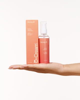 A woman hand holding Peach and Cream personal lubricant Honey