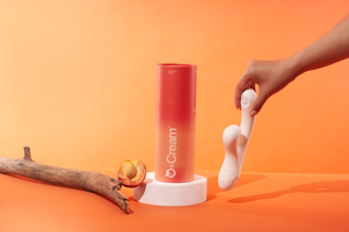 Woman holding Peach and Cream vibrator white version