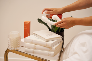 Woman pouring Montreal Brand peach and cream lubricant on vibrator