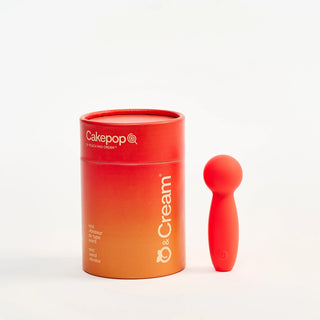 Red and orange container with Peach and Cream 'Cakepop' vibrator on a white background