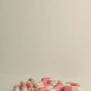 small capsules on a pale surface