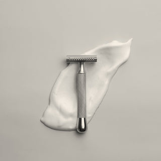 a safety razor on a swipe of shaving cream