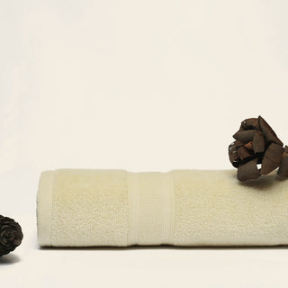 a rolled cream towel on white