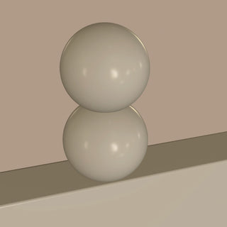 two smooth spheres stacked on a ledge