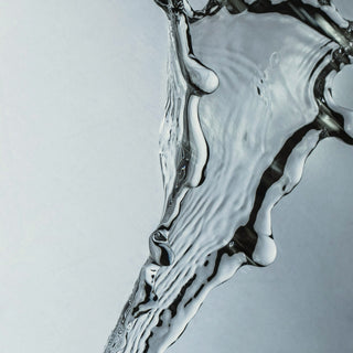 A splash of clear water against a pale background