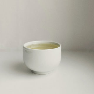 a cup of herbal tea on white