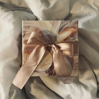 a gift wrapped with a satin ribbon on soft linen