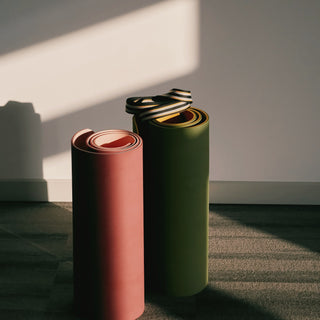 two rolled yoga mats in afternoon light