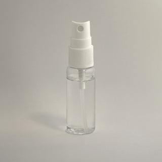 a clear spray bottle on a light background