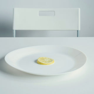 a small white plate on a white table