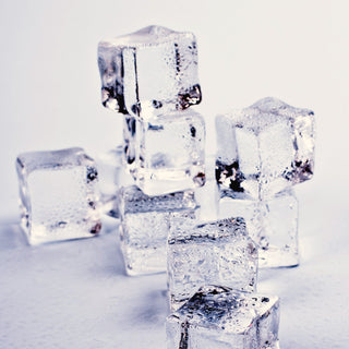 Clear ice cubes on a white surface