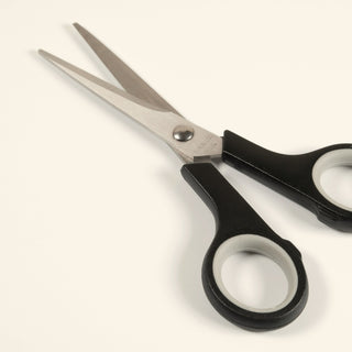 a pair of small scissors on a light background