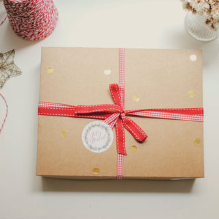 a kraft gift box tied with a red ribbon