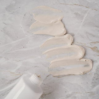 Swatches of cream on a white marble surface