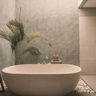 a freestanding bathtub in a calm bathroom