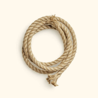 A coiled jute rope on a white background