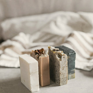 Handmade soap bars resting on linen
