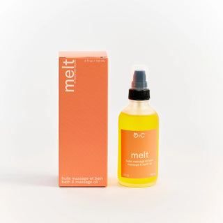 Bottle and box of Peach and Cream 'melt' bath and massage oil on a white background