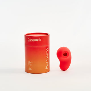 Red cylindrical container with Peach and Cream 'Cakepop' vibrator on a white background