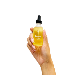 Hand holding a bottle labeled Peach and Cream shaving primer 'base' 