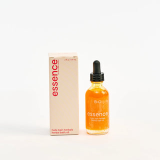 Bottle and box of Peach and Cream 'essence' herbal bath oil on a white background