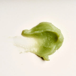 Close-up texture of Peach and Cream 'Lips' vulva balm on a white background