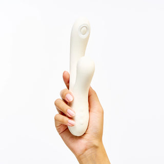 Hand holding Peach and Cream 'Peak' vibrator white version