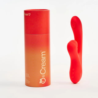 Red and orange cylindrical container with Peach and Cream 'Peak' vibrator, red version on a white background