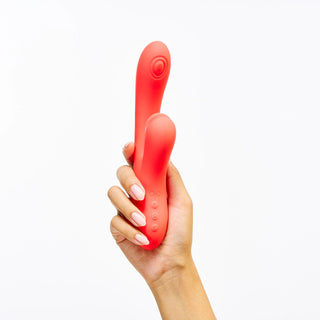 Hand holding Peach and Cream 'Peak' vibrator red version