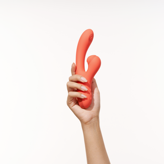 A woman hand holding Peach and Cream vibrator red version