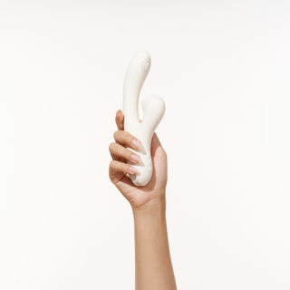 A woman hand holding Peach and Cream vibrator Peak white version